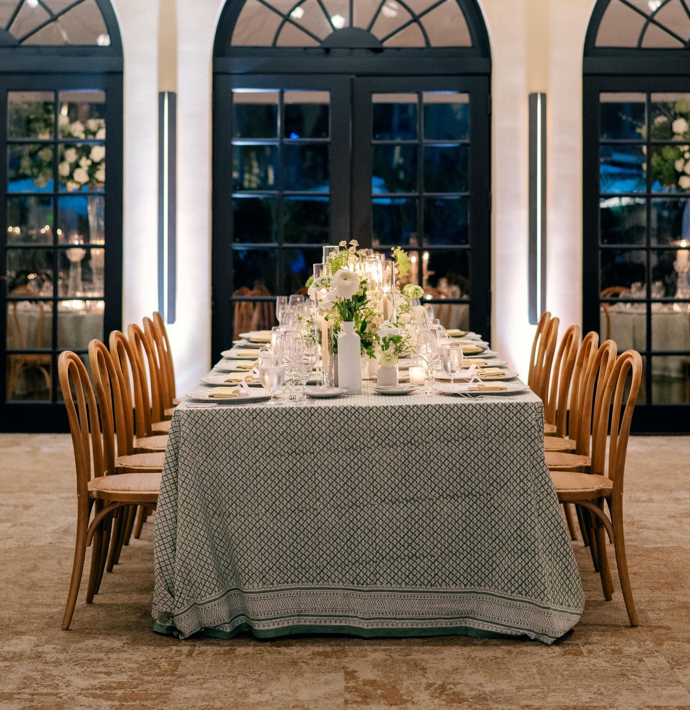 Long table under a green block-printed cloth with a wide printed border