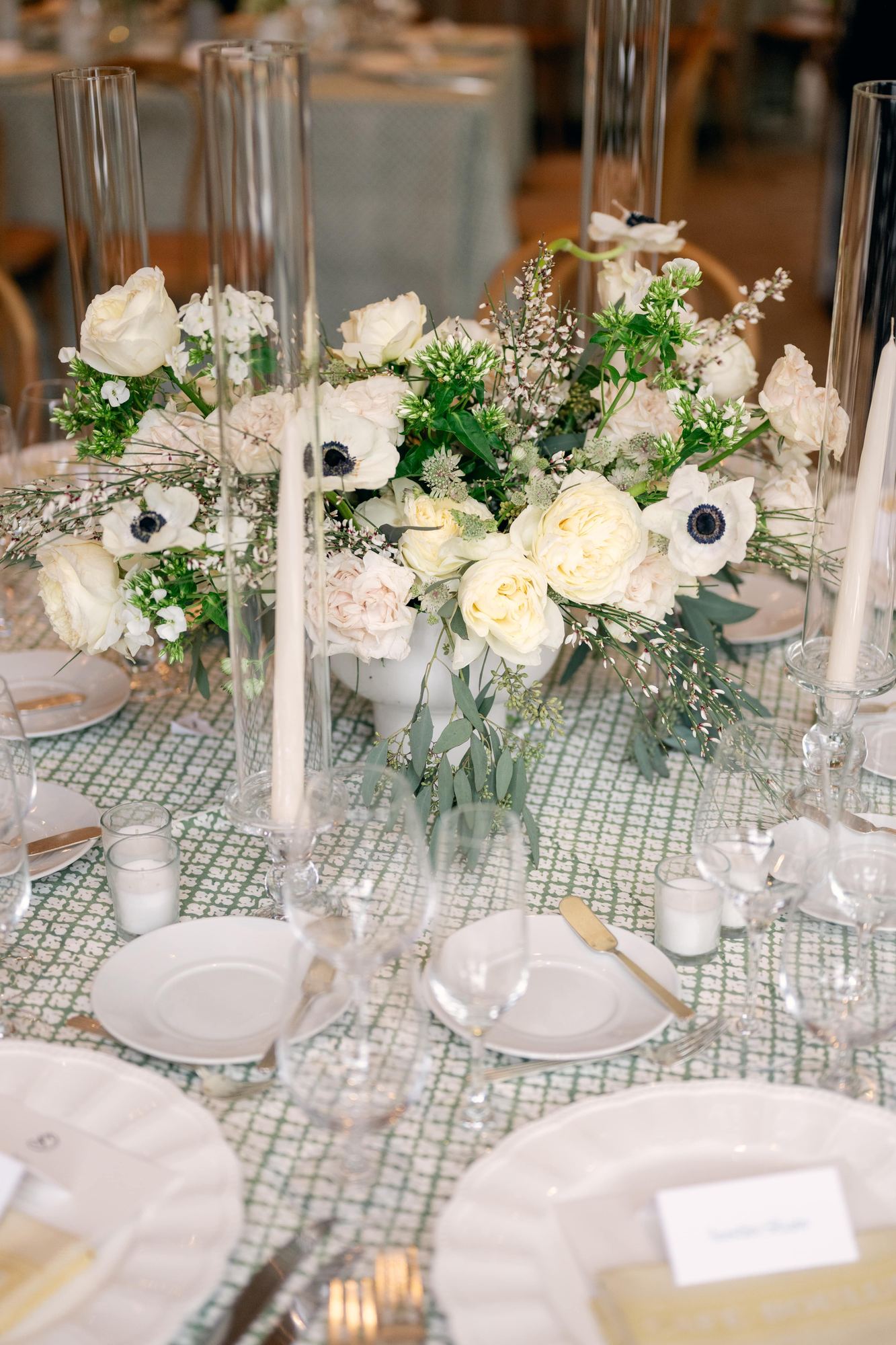 White anemone and garden rose centrepiece on a green printed cloth