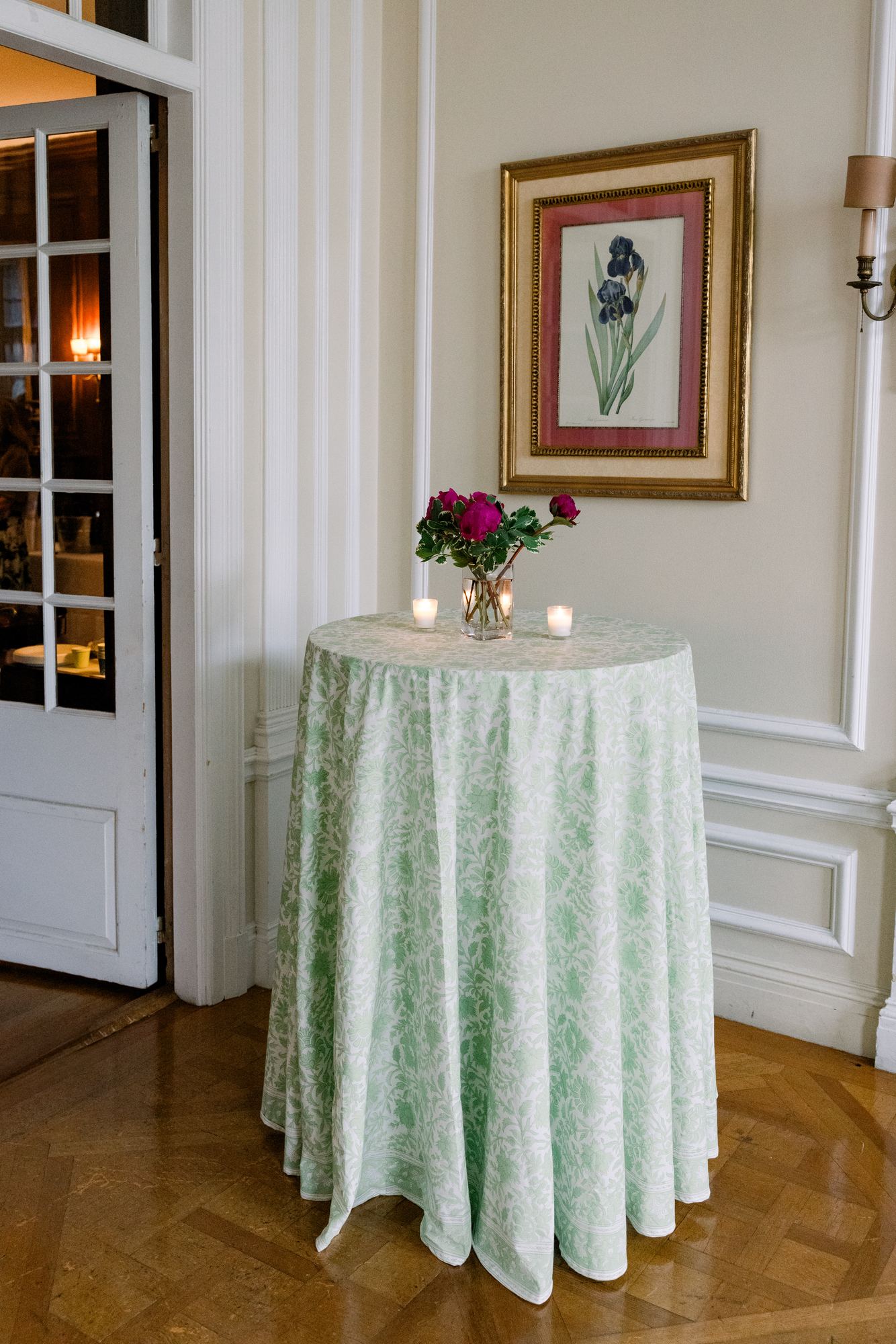 Cocktail table in a green floral block print in a panelled room