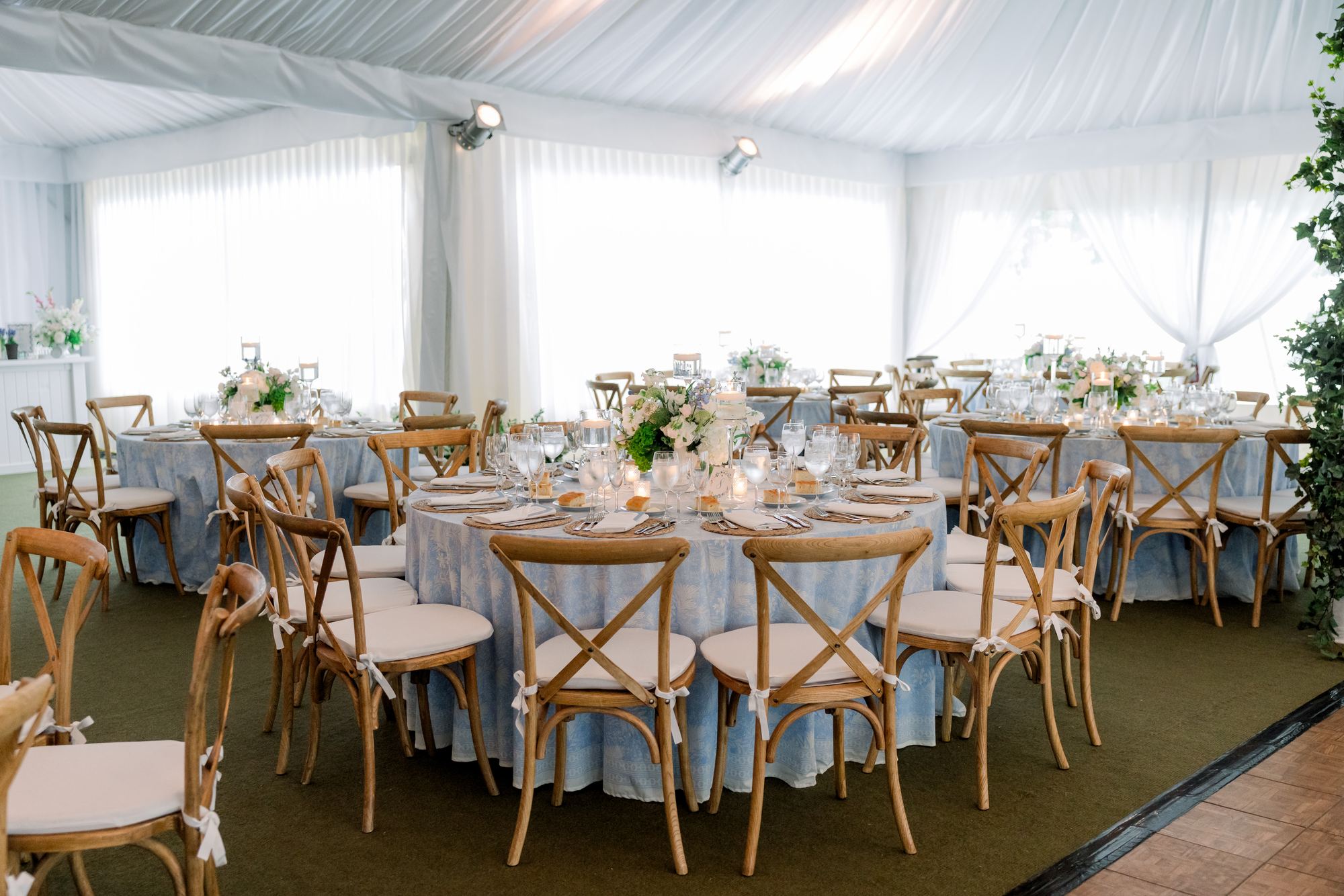 Tented reception with every round table dressed in the Nila Blue print
