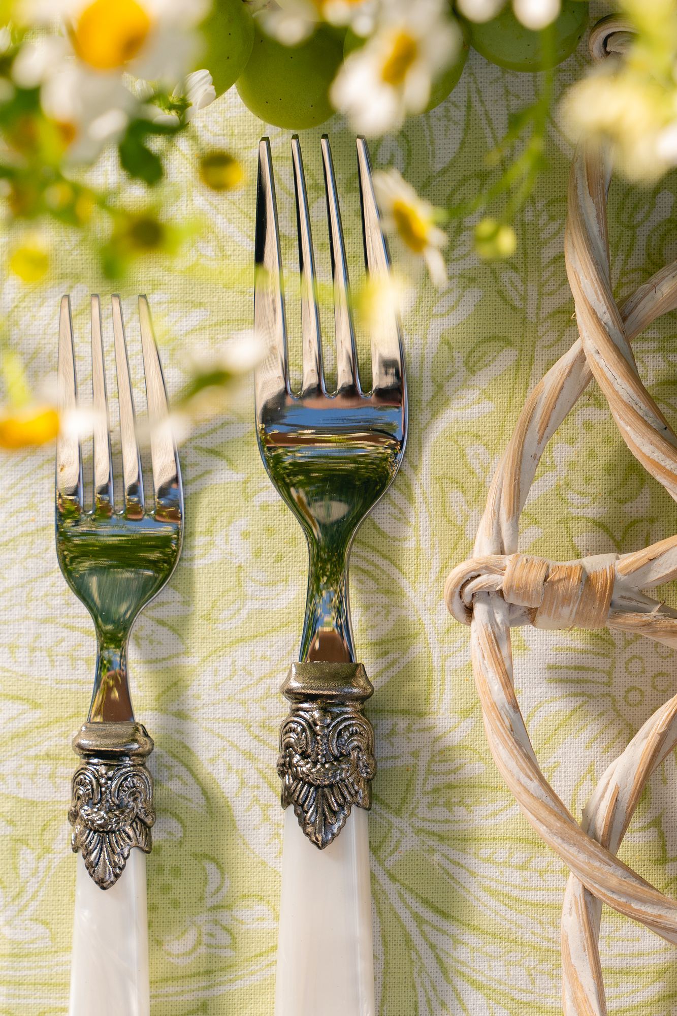 Mother-of-pearl handled forks resting on a citron floral block print