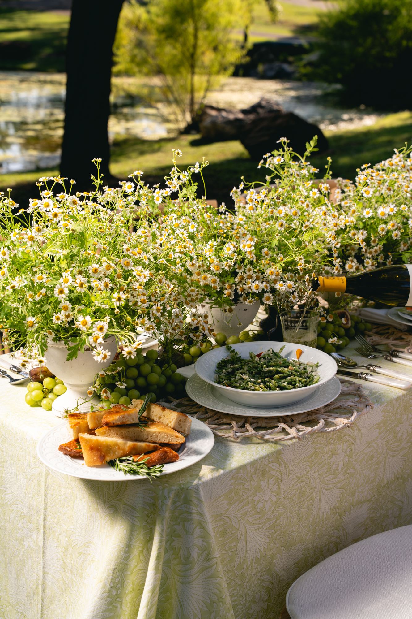 Citron block-printed cloth beneath platters of focaccia and greens